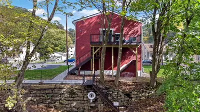 a red house with a ramp leading up to it at Riverview in Port Clinton - Apt. B in Port Clinton