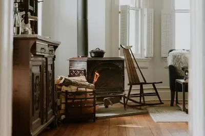 a living room with an old wood stove in it at The North Branch Inn in North Branch