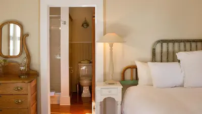 a bedroom with a bed and a bathroom with a toilet at The North Branch Inn in North Branch