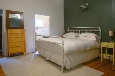 a bedroom with a bed and a dresser and a mirror at The North Branch Inn in North Branch