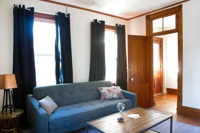 a living room with a blue couch and a table at The North Branch Inn in North Branch