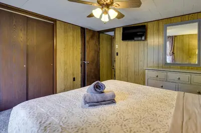 a bedroom with a bed with a towel on it at Fire Pit Arrowhead Lake Vacation Rental! in Pocono Lake