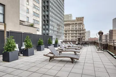 a row of benches on a balcony in a city at Fidi 1br w doorman wd nr south st seaport NYC-1306 in New York