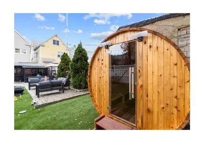 a wooden building with a large glass door in a yard at Epic Spa & Play Retreat NYC EWR Sleeps 30! in Bayonne