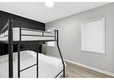 a bedroom with two bunk beds and a window at Epic Spa & Play Retreat NYC EWR Sleeps 30! in Bayonne