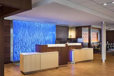 a lobby with a blue wall in a building at Fairfield Inn & Suites by Marriott New Castle in New Castle