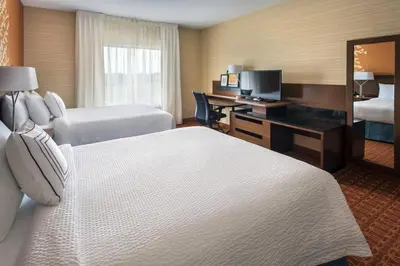 a hotel room with two beds and a desk with a computer at Fairfield Inn & Suites by Marriott New Castle in New Castle