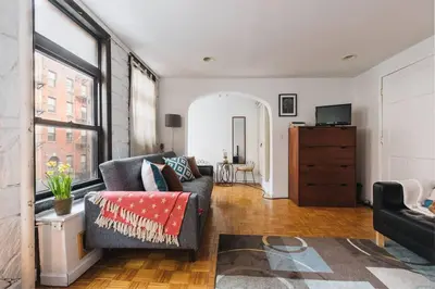 a living room with a couch and a television at East Village Townhouse in New York