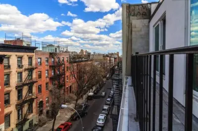 a view of a city street from a balcony at East Village Townhouse in New York