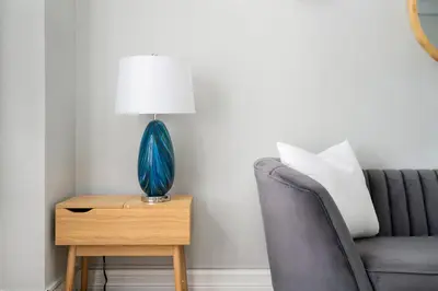 a blue lamp on a table next to a couch at 73-201 New 1BR 1Bth UWS Doorman Gym in New York