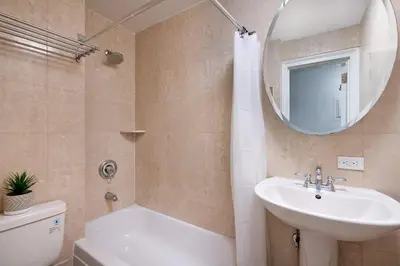 a bathroom with a sink and a toilet and a mirror at 73-201 New 1BR 1Bth UWS Doorman Gym in New York