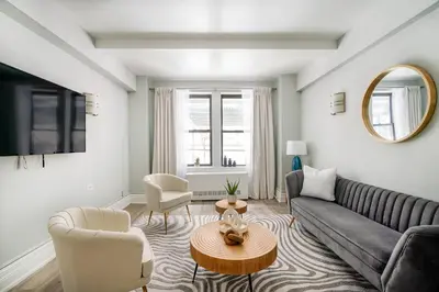 a living room with a couch and a table at 73-201 New 1BR 1Bth UWS Doorman Gym in New York