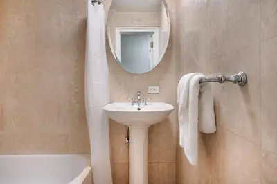a bathroom with a sink and a mirror at 73-201 New 1BR 1Bth UWS Doorman Gym in New York