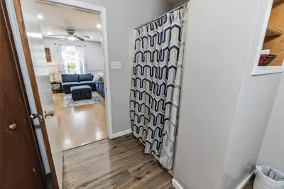 a hallway with a door leading to a living room at Horatio Hideaway Pocono Escape in Tobyhanna
