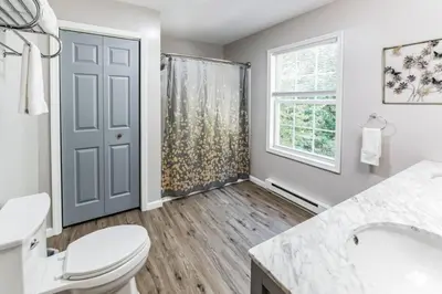 a bathroom with a toilet and a shower at Horatio Hideaway Pocono Escape in Tobyhanna