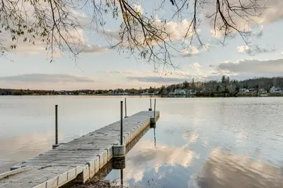 a dock in the middle of a body of water at Cozy Pennsylvania Home with Fire Pit and Dock Access! in Carbondale