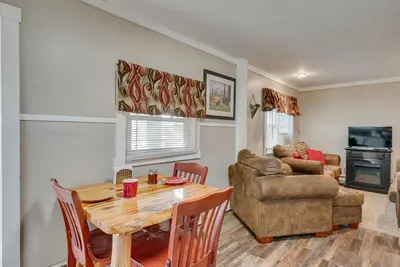 a living room with a table and a couch at Cozy Pennsylvania Home with Fire Pit and Dock Access! in Carbondale