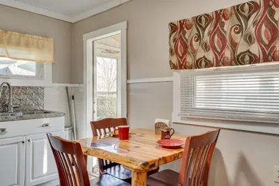 a kitchen with a wooden table and chairs at Cozy Pennsylvania Home with Fire Pit and Dock Access! in Carbondale