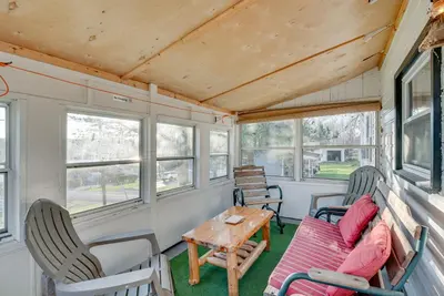 a living room of a tiny house with a table and chairs at Cozy Pennsylvania Home with Fire Pit and Dock Access! in Carbondale