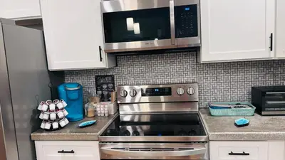 a kitchen with a stainless steel stove and a microwave at Long pond, Pocono pines quiet & cozy!Kalahari 8mins in Pocono Pines
