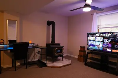 a living room with a stove and a television at Long pond, Pocono pines quiet & cozy!Kalahari 8mins in Pocono Pines