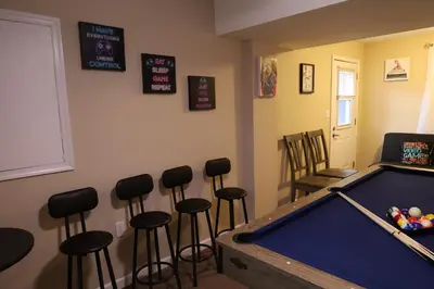 a room with a pool table and bar stools at Long pond, Pocono pines quiet & cozy!Kalahari 8mins in Pocono Pines