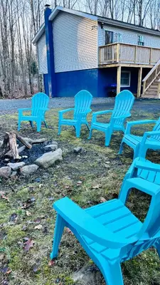 a group of blue chairs sitting in the yard at Long pond, Pocono pines quiet & cozy!Kalahari 8mins in Pocono Pines