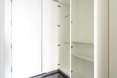 a closet with white cabinets and a window at Financial District 1br w WD gym elevator NYC-1360 in New York