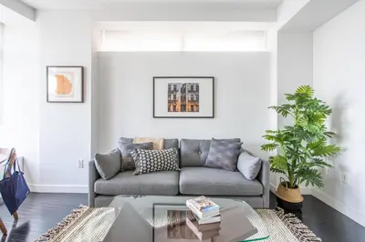 a living room with a couch and a table at Financial District 1br w WD gym elevator NYC-1360 in New York