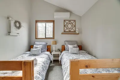 a bedroom with two beds and a window at Pocono Pines Home with Private Hot Tub! in Pocono Pines