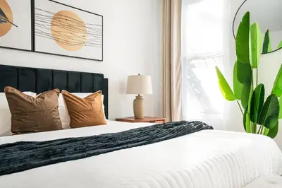 a bedroom with a white bed and a plant at 444-2E Modern 2BR Hell's Kitchen in New York