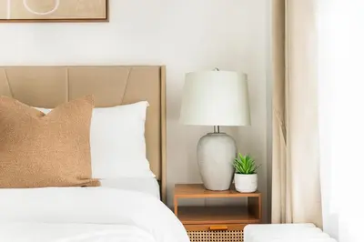 a bedroom with a bed and a lamp on a table at 444-2E Modern 2BR Hell's Kitchen in New York