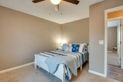 a bedroom with a bed with a blue comforter at Family Home on Lake Newton with Deck and Fire Pit in Carbondale