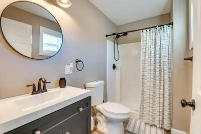 a bathroom with a sink and a toilet and a mirror at Family Home on Lake Newton with Deck and Fire Pit in Carbondale