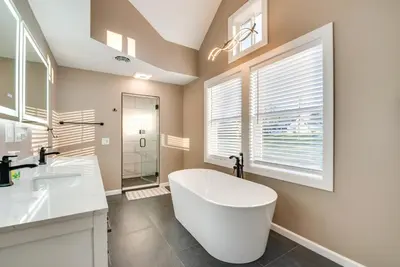 a bathroom with a large white tub and a shower at Family Home on Lake Newton with Deck and Fire Pit in Carbondale
