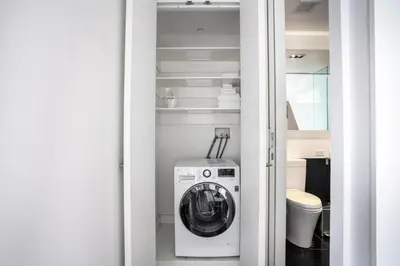 a washer and dryer in a small bathroom at Financial District 1br w WD gym elevator NYC-1378 in New York