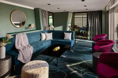 a living room with a blue couch and purple chairs at Financial District 1br w WD gym elevator NYC-1378 in New York