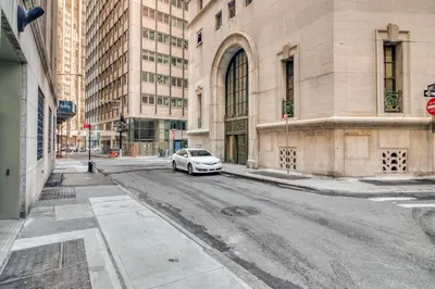 a white car parked on the side of a city street at FiDi jr 1br w game room resident-only bar NYC-1336 in New York