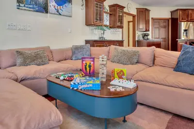 a living room with a couch and a table with toys at Poconos Playtime Paradise Luxury Play Escape in Pocono Pines