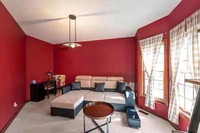 a bedroom with a bed and a red wall at Poconos Playtime Paradise Luxury Play Escape in Pocono Pines