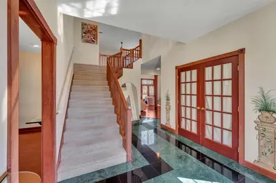a staircase in a home with wooden railings at Poconos Playtime Paradise Luxury Play Escape in Pocono Pines
