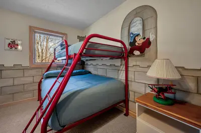 a bedroom with a bunk bed and a desk at Poconos Playtime Paradise Luxury Play Escape in Pocono Pines