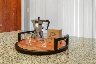 a coffee maker and glasses on a tray on a counter at Greenridge Getaway:Near Universities & Attractions in Scranton