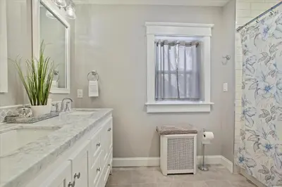 a white bathroom with a sink and a shower at Greenridge Getaway:Near Universities & Attractions in Scranton
