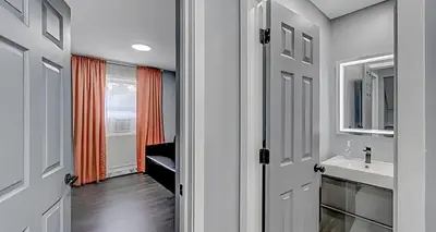 a bathroom with a sink and a mirror at Peaceful Pocono Home with Hot Tub, gym, & office in Long Pond
