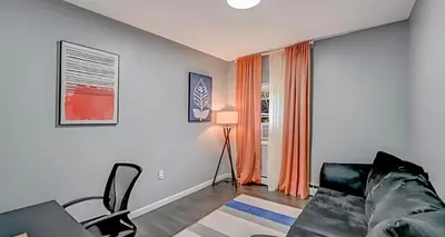 a living room with a couch and a window at Peaceful Pocono Home with Hot Tub, gym, & office in Long Pond