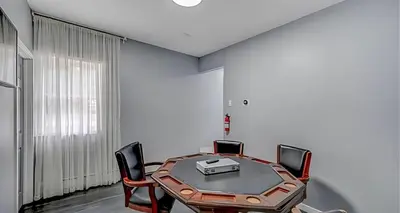 a meeting room with a table and chairs at Peaceful Pocono Home with Hot Tub, gym, & office in Long Pond