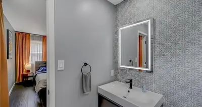 a bathroom with a sink and a mirror at Peaceful Pocono Home with Hot Tub, gym, & office in Long Pond