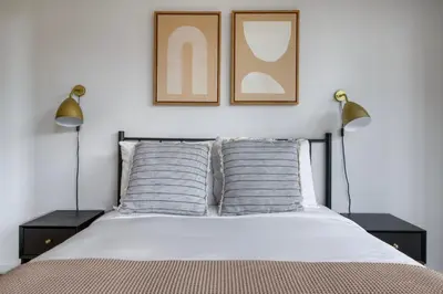 a bedroom with two lamps and a bed with two pillows at Upper West Side 2br w rooftop gym nr park NYC-1216 in New York