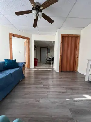 a living room with a couch and a ceiling fan at Comfy Apt near Guthrie RPH Sayre in Sayre